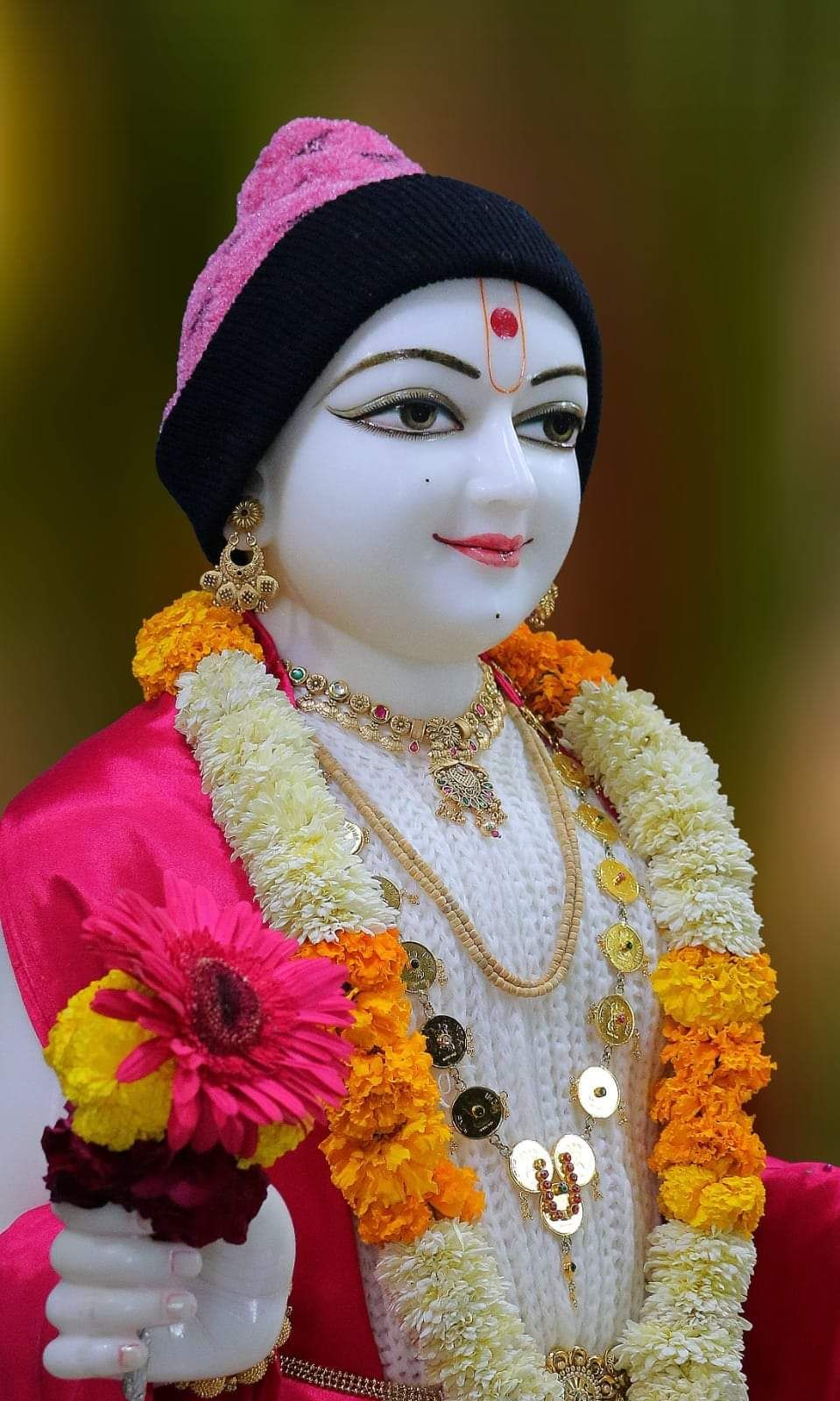 Swaminarayan deity with floral garland