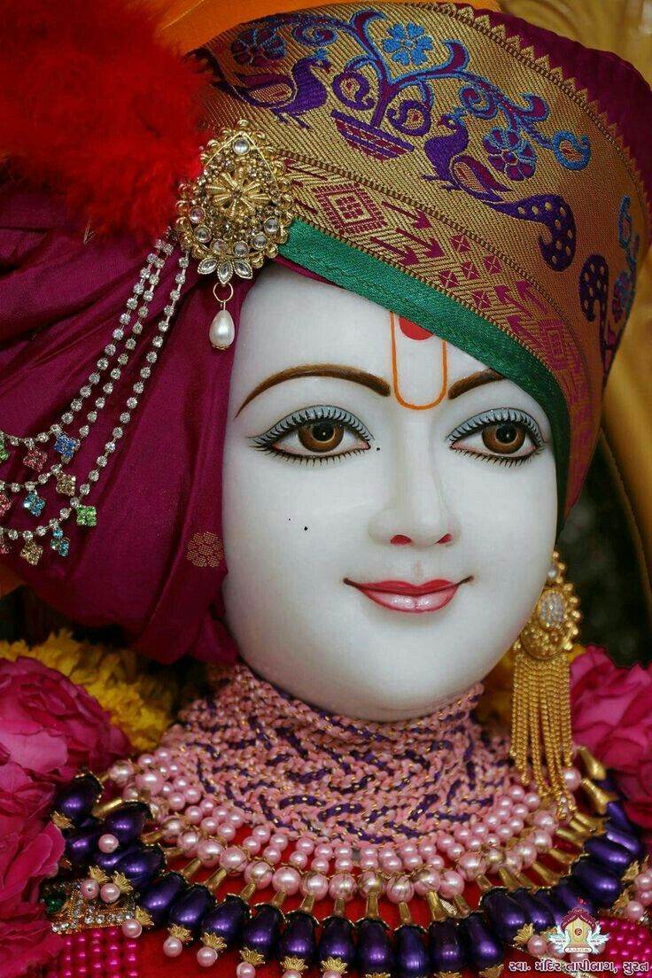 Swaminarayan with ornate jewelry and headwear