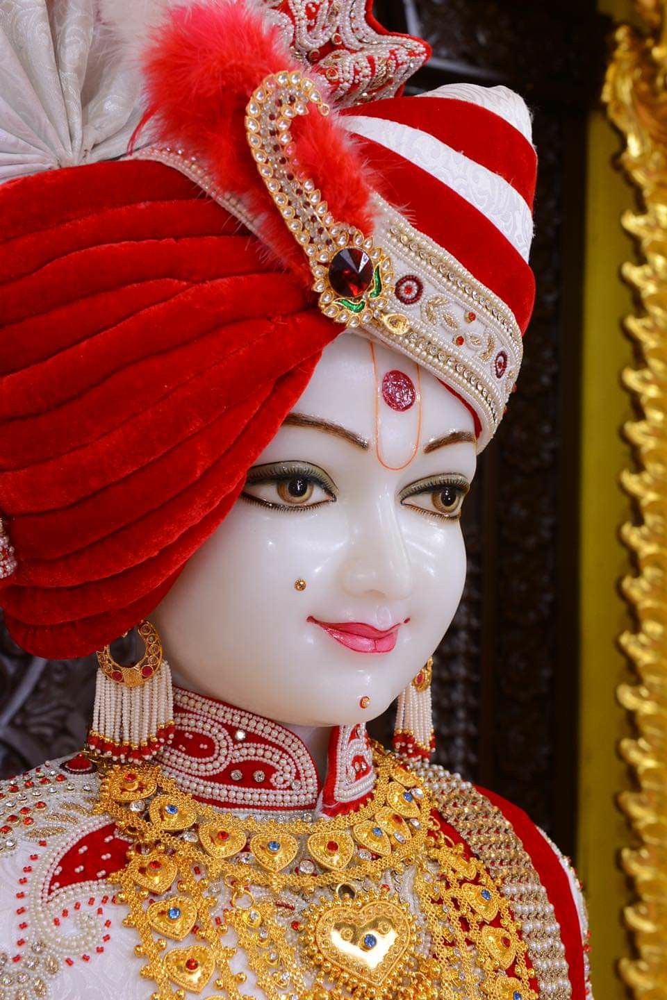 Close-up of serene Swaminarayan idol.