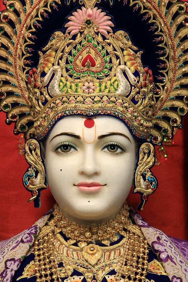 Close-up of Swaminarayan\'s serene face.