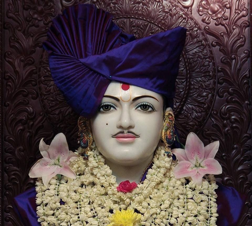 Swaminarayan Bhagwan with lilies and garland