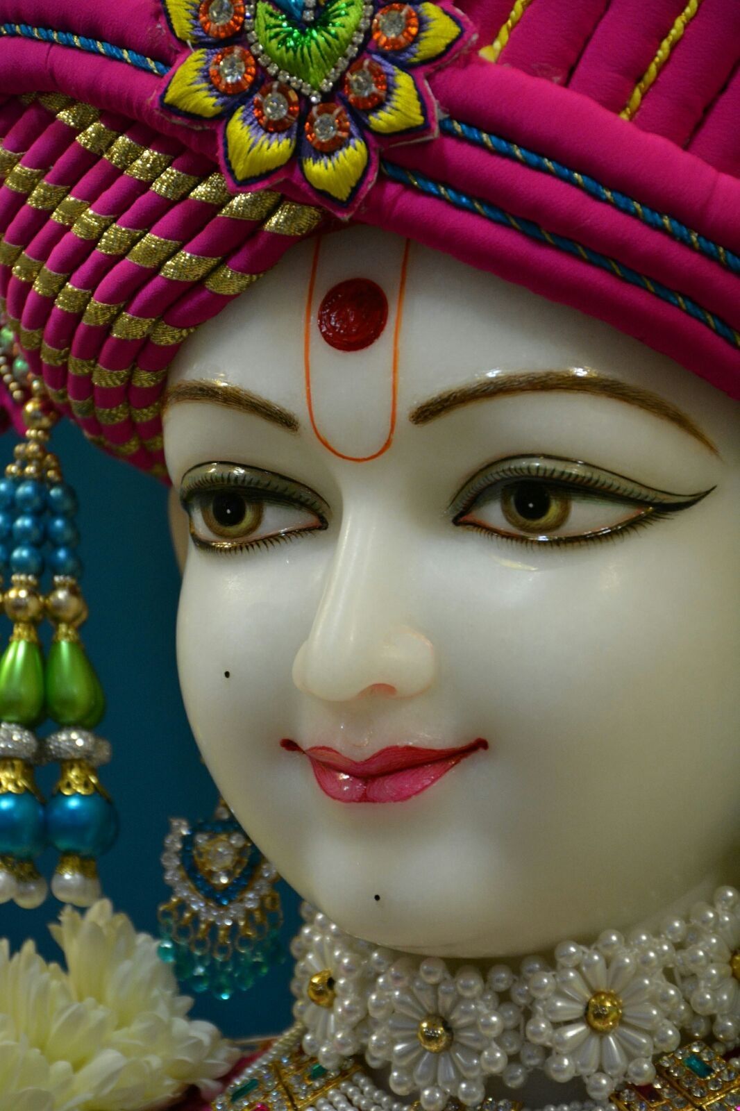 Close-up of serene Swaminarayan face.