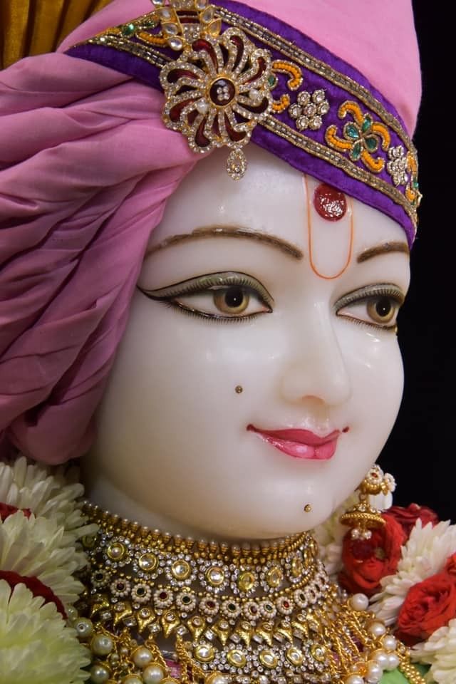 Close-up of Swaminarayan\'s serene face.