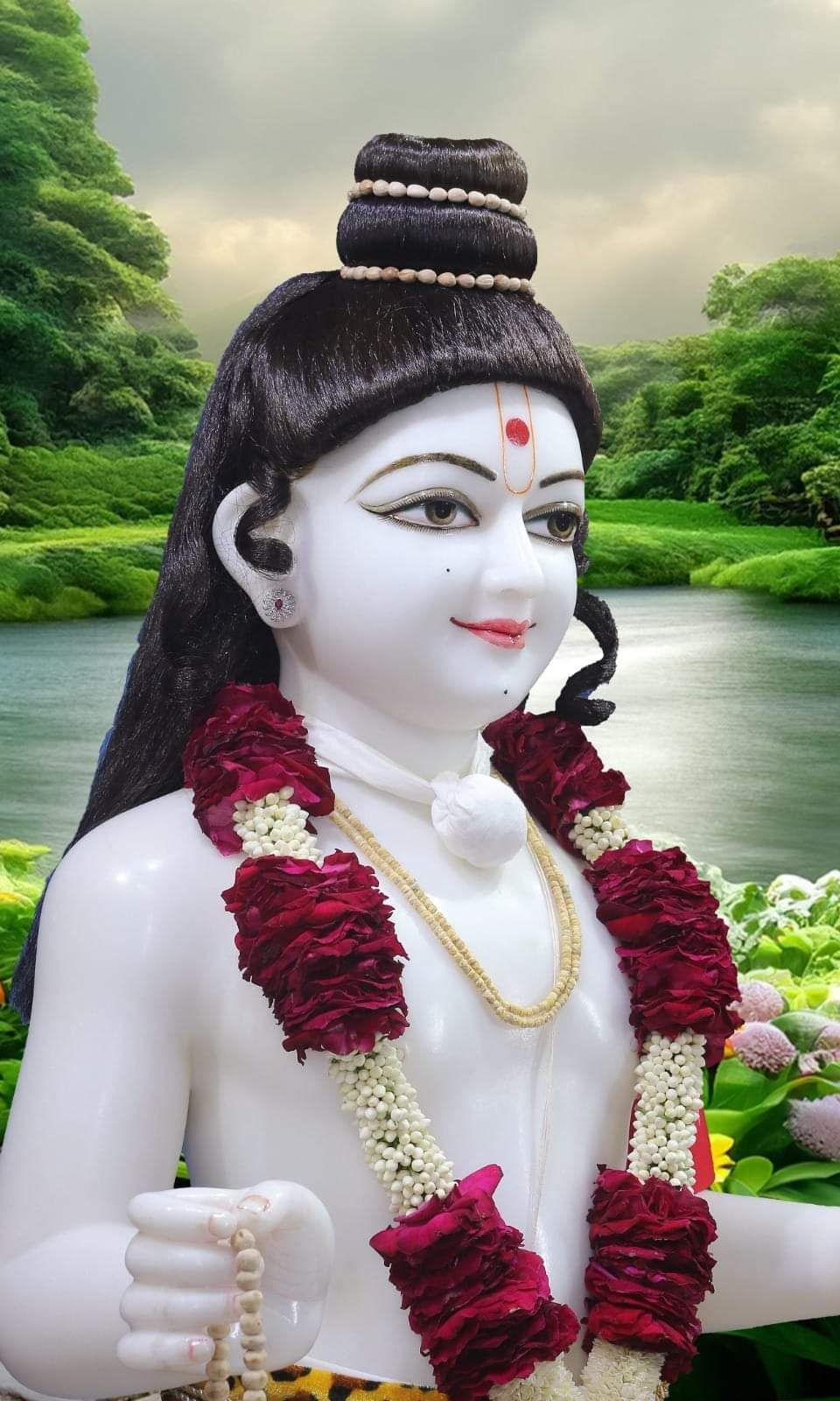 Peaceful Swaminarayan statue amidst nature.