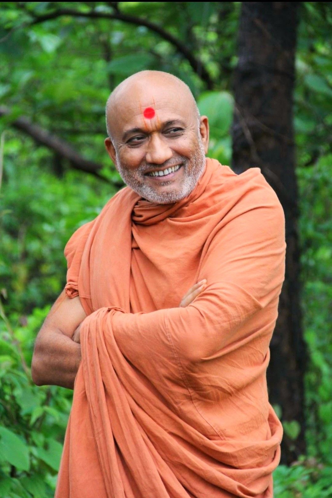 Smiling Swaminarayan amidst lush greenery