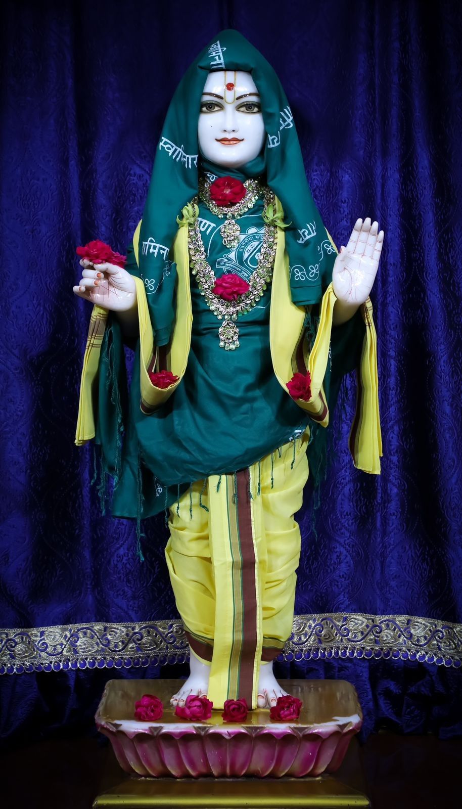 Swaminarayan deity with floral adornments