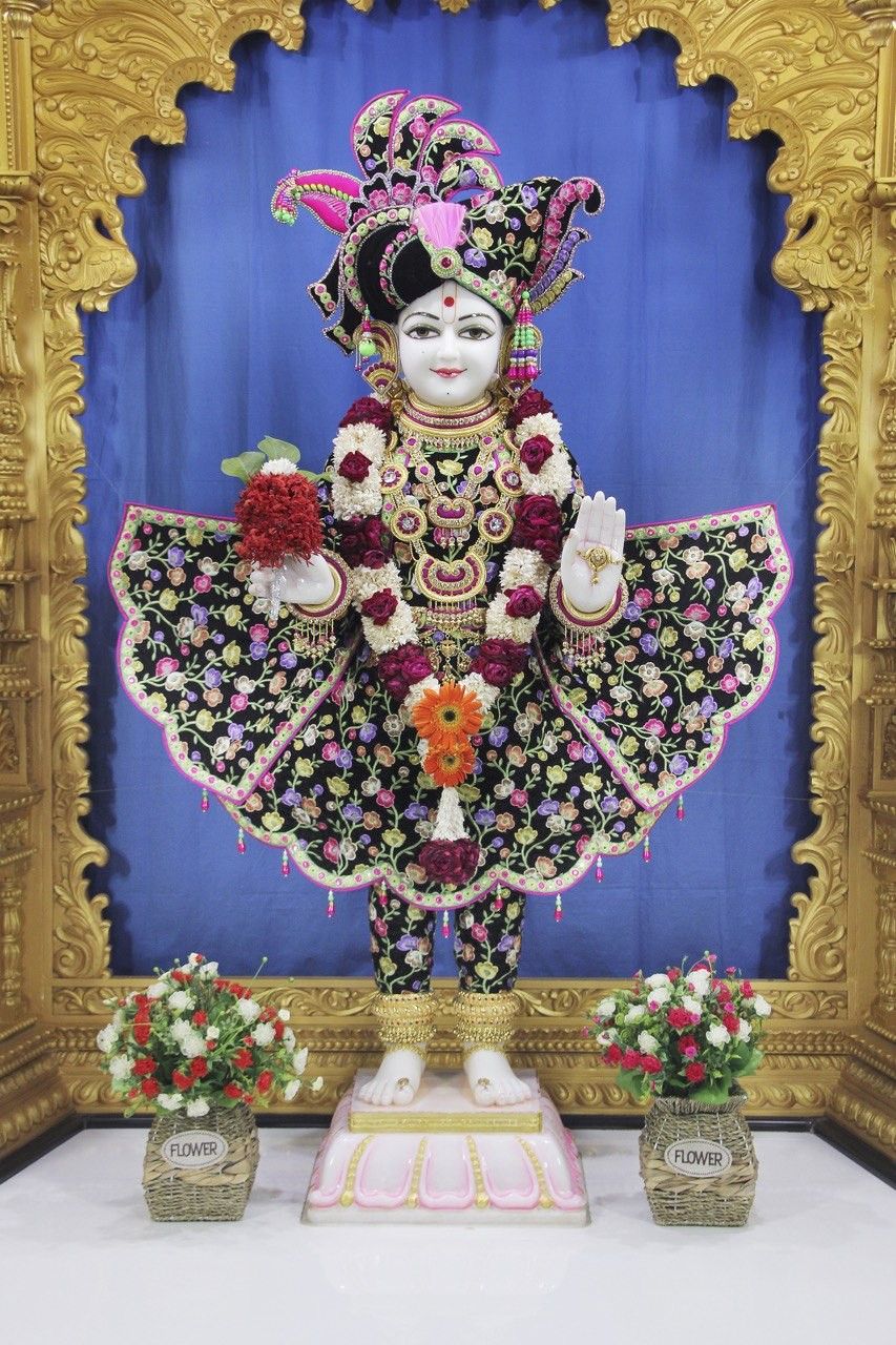 Swaminarayan adorned with vibrant floral garlands