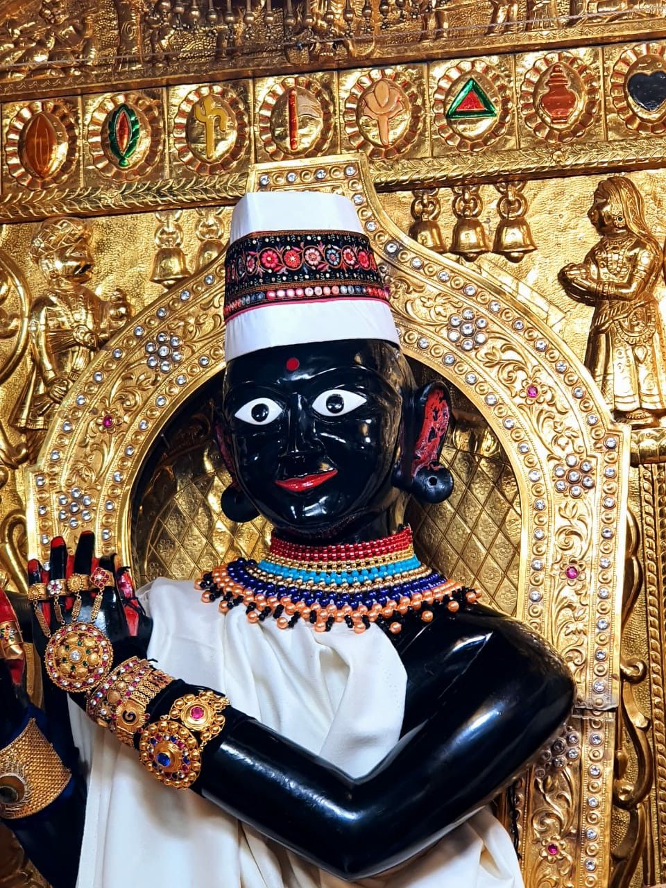 Swaminarayan with ornate gold backdrop