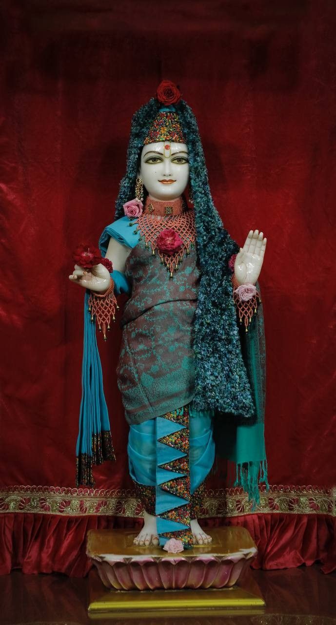 Beautiful Swaminarayan deity statue with flowers