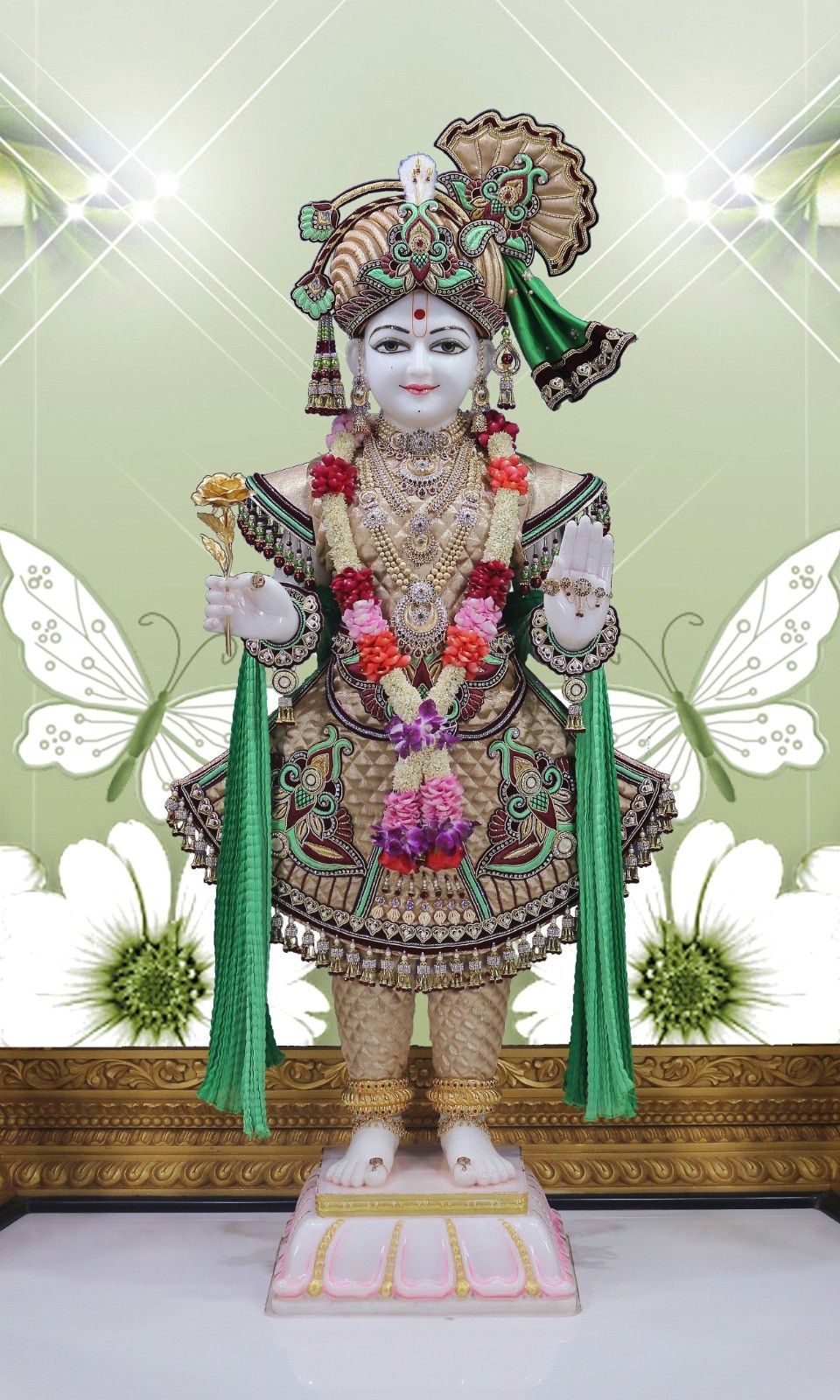 Shri Swaminarayan statue with floral adornments