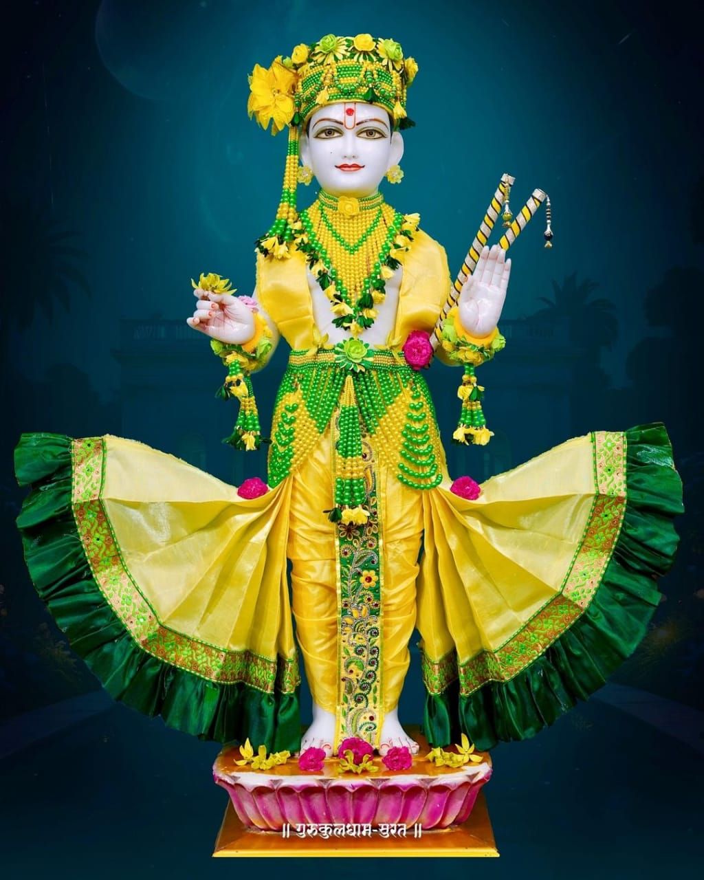 Swaminarayan Bhagwan in ornate yellow attire