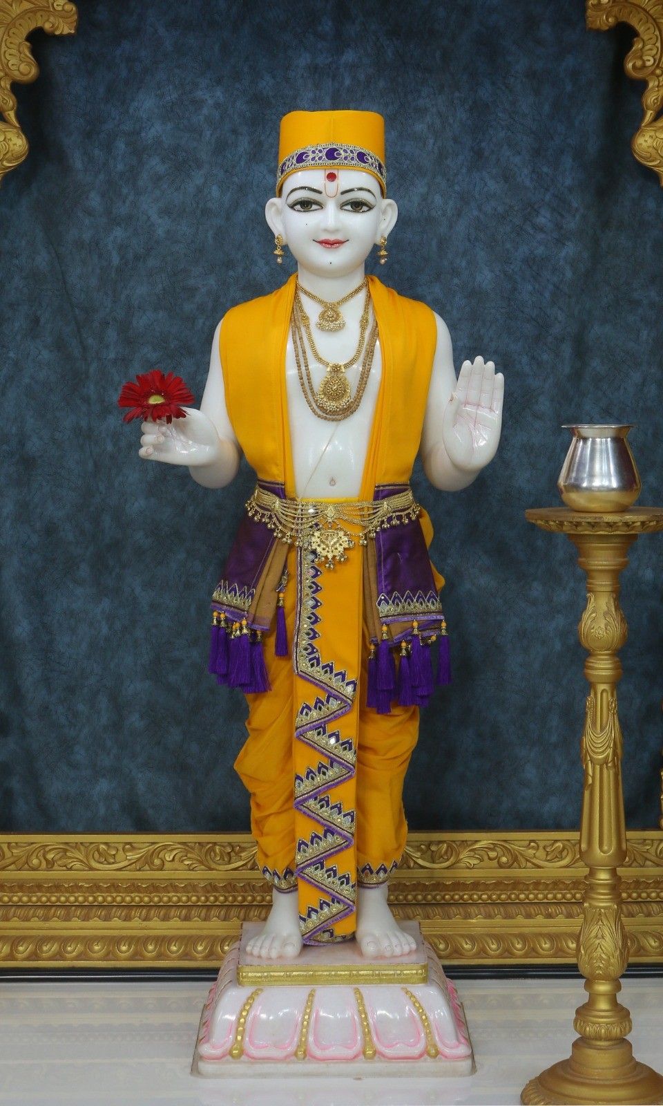 Swaminarayan Maharaj statue with flower offering