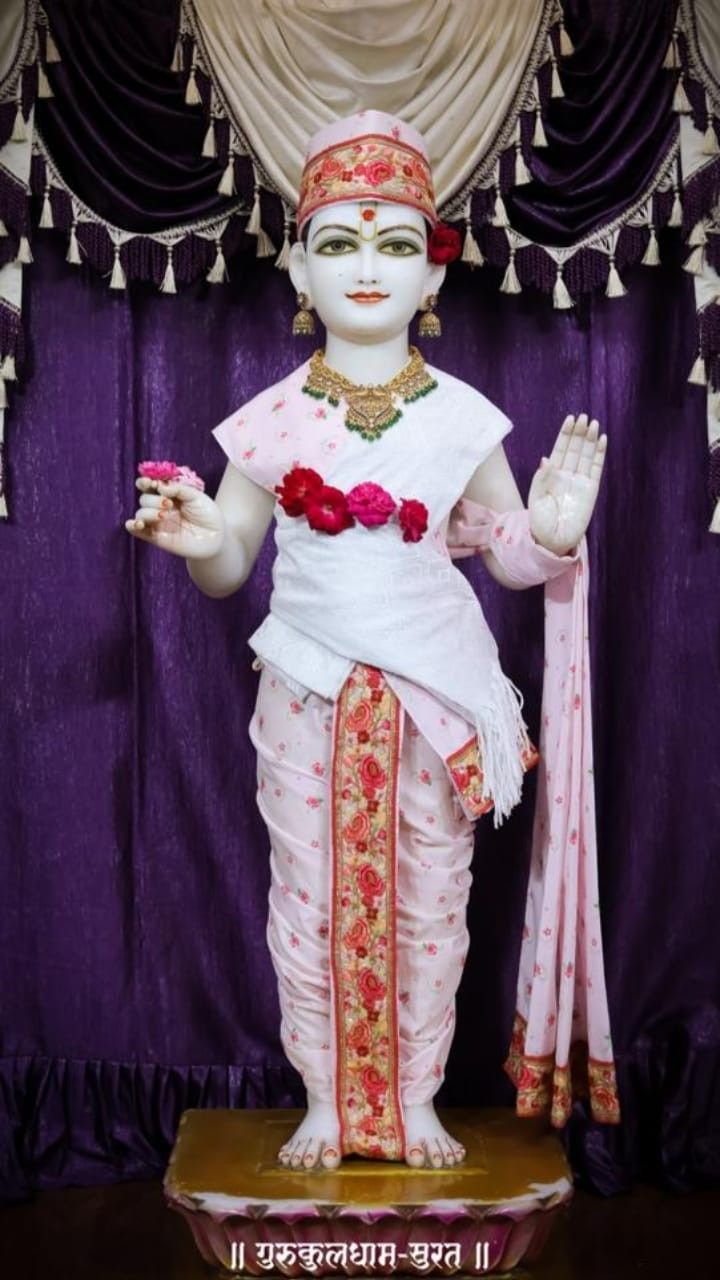Swaminarayan statue adorned with flowers