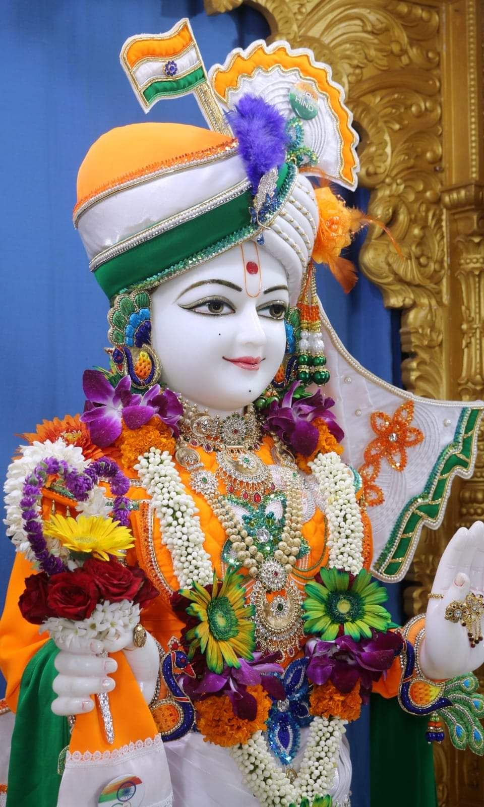 Swaminarayan adorned with vibrant floral garland
