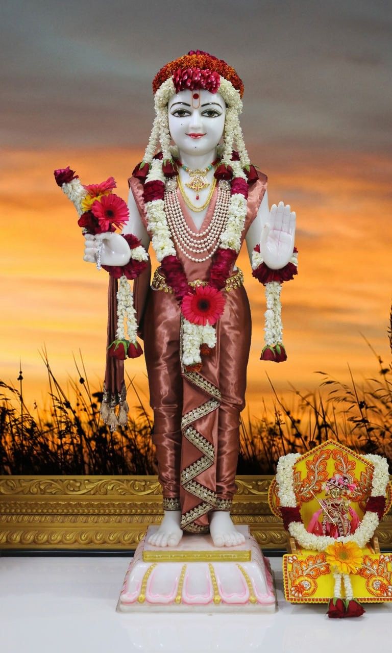 Swaminarayan statue with floral offerings.
