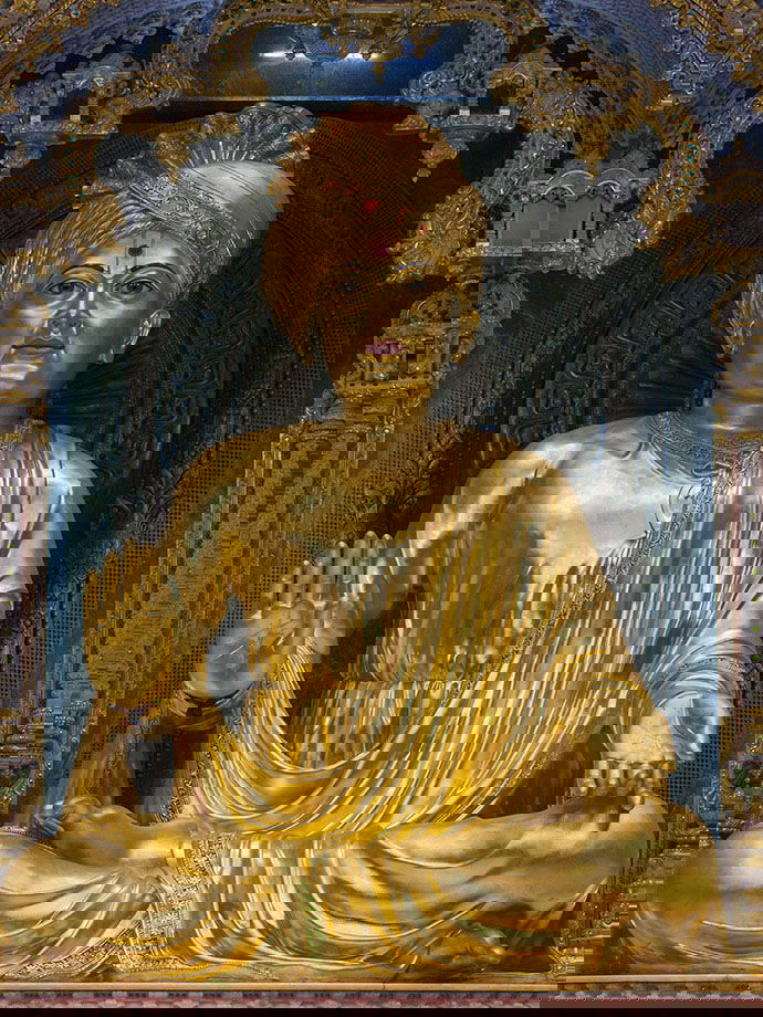 Golden statue of Swaminarayan in temple