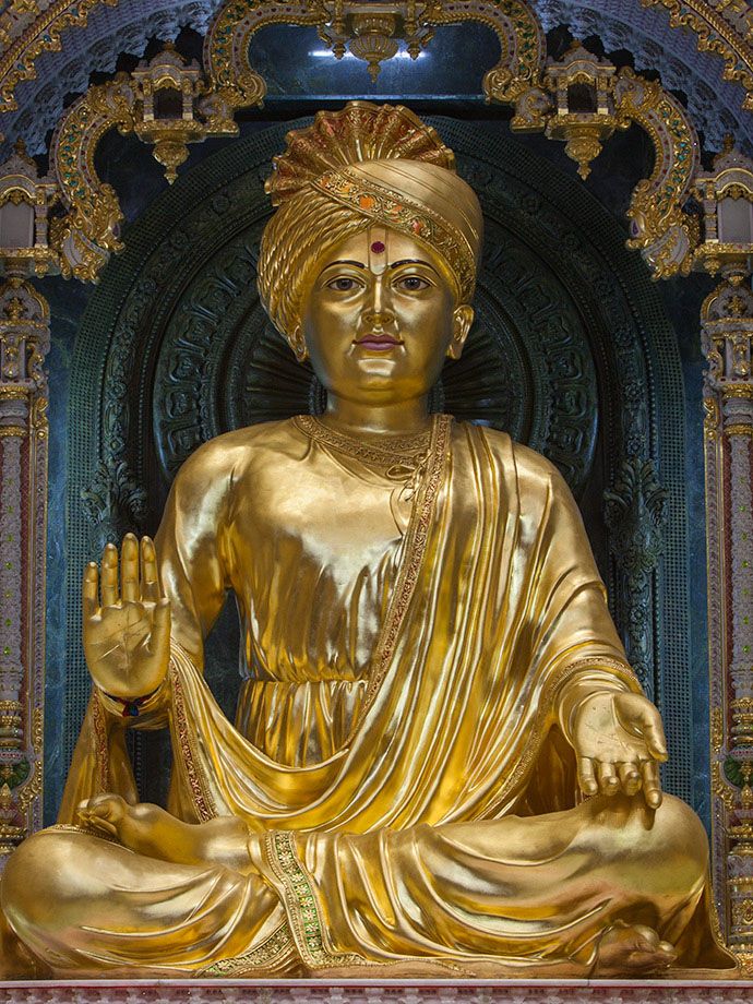 Golden Swaminarayan statue in temple setting