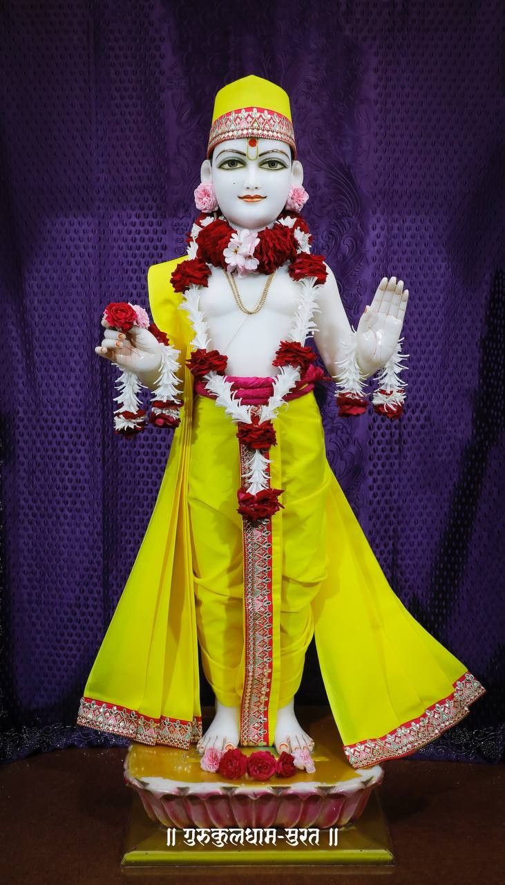 Swaminarayan statue with blessing gesture.