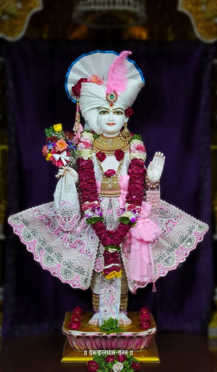 Swaminarayan statue adorned with flowers