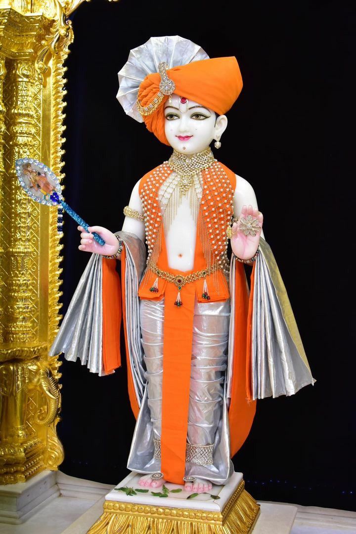 Swaminarayan statue with floral base.