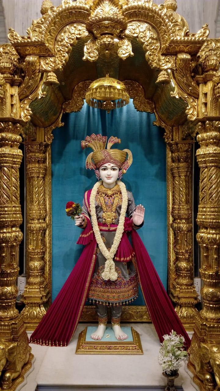 Swaminarayan deity in ornate golden frame