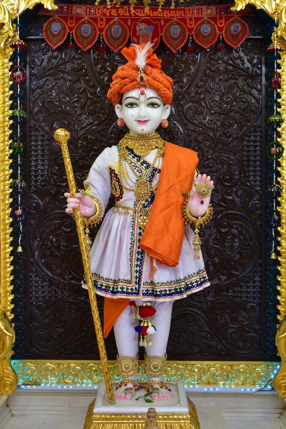 Swaminarayan statue in ornate temple setting