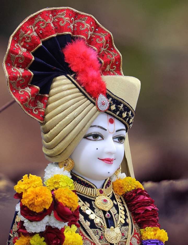 Swaminarayan with floral garland and turban.