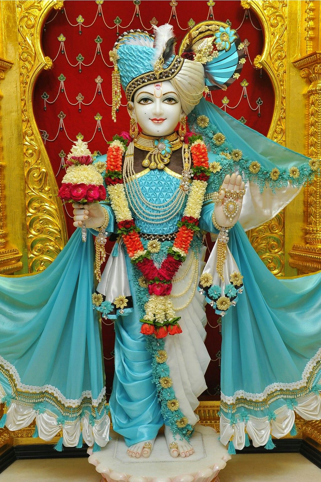 Swaminarayan deity with floral garland