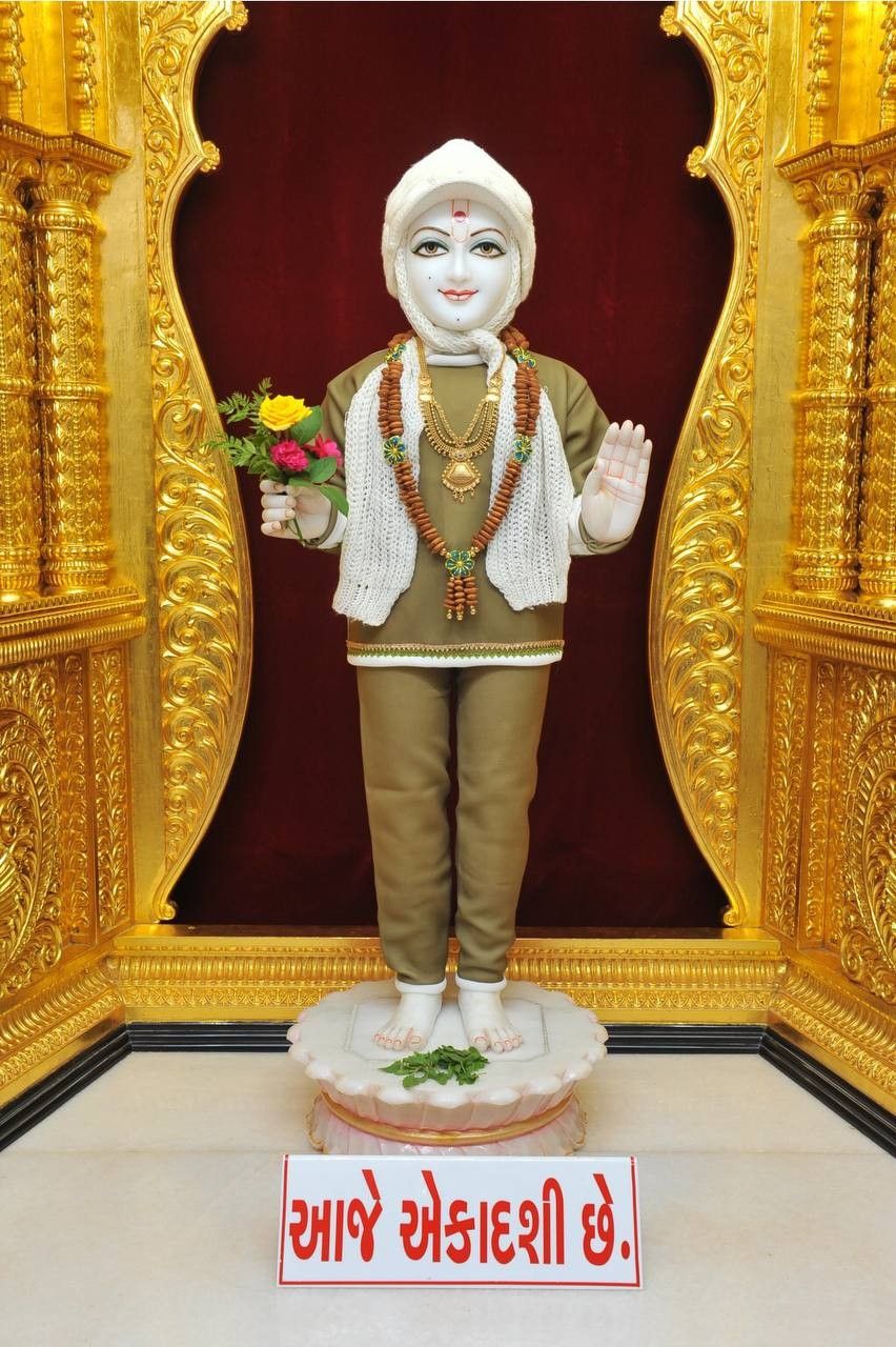 Swaminarayan statue with floral offering.