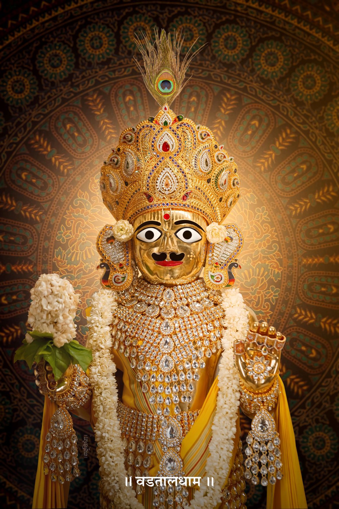 Swaminarayan deity adorned in gold jewelry